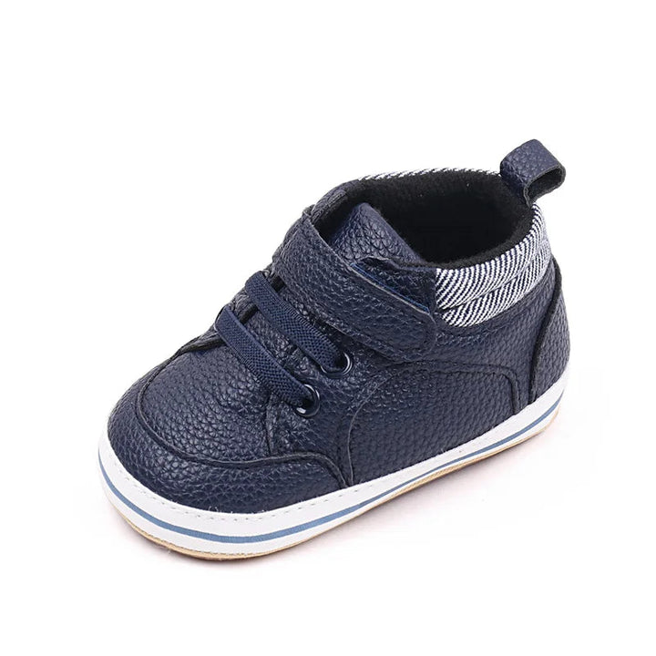 Blue baby sneaker with a hook-and-loop strap, striped collar, and heel pull tab