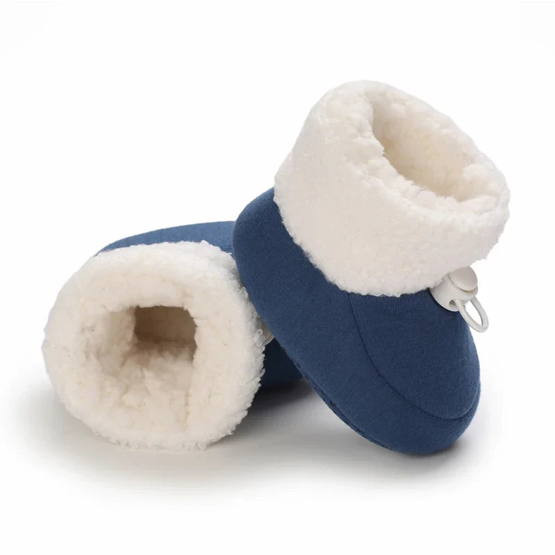 Blue baby winter boots with one opening facing forward to show the fluffy lining