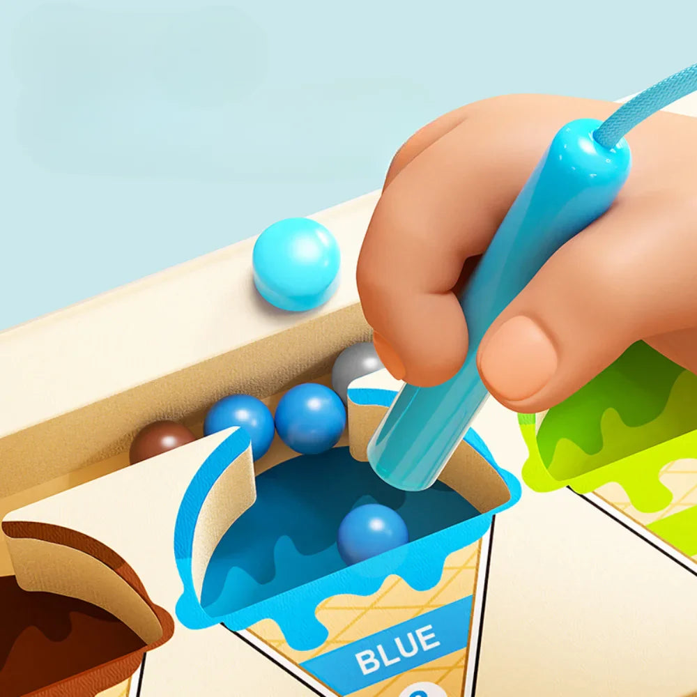 Close-up of a hand holding the magnetic pen over blue beads in the blue cone