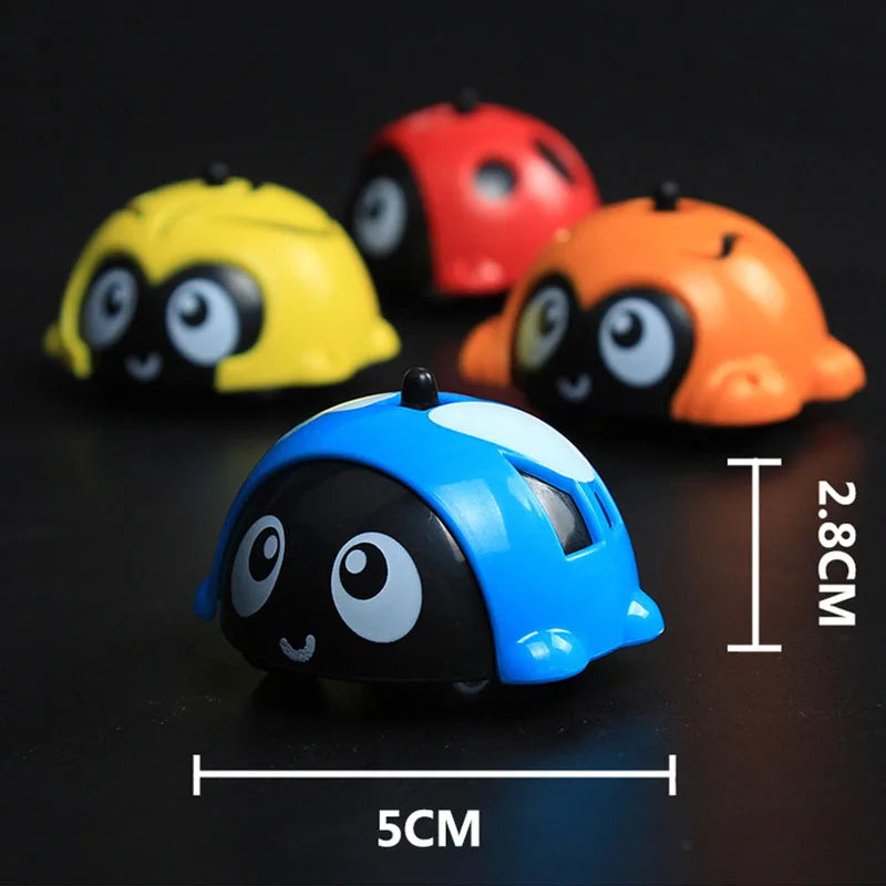 Blue animal toy car beside measurement labels, with yellow, red, and orange cars behind it