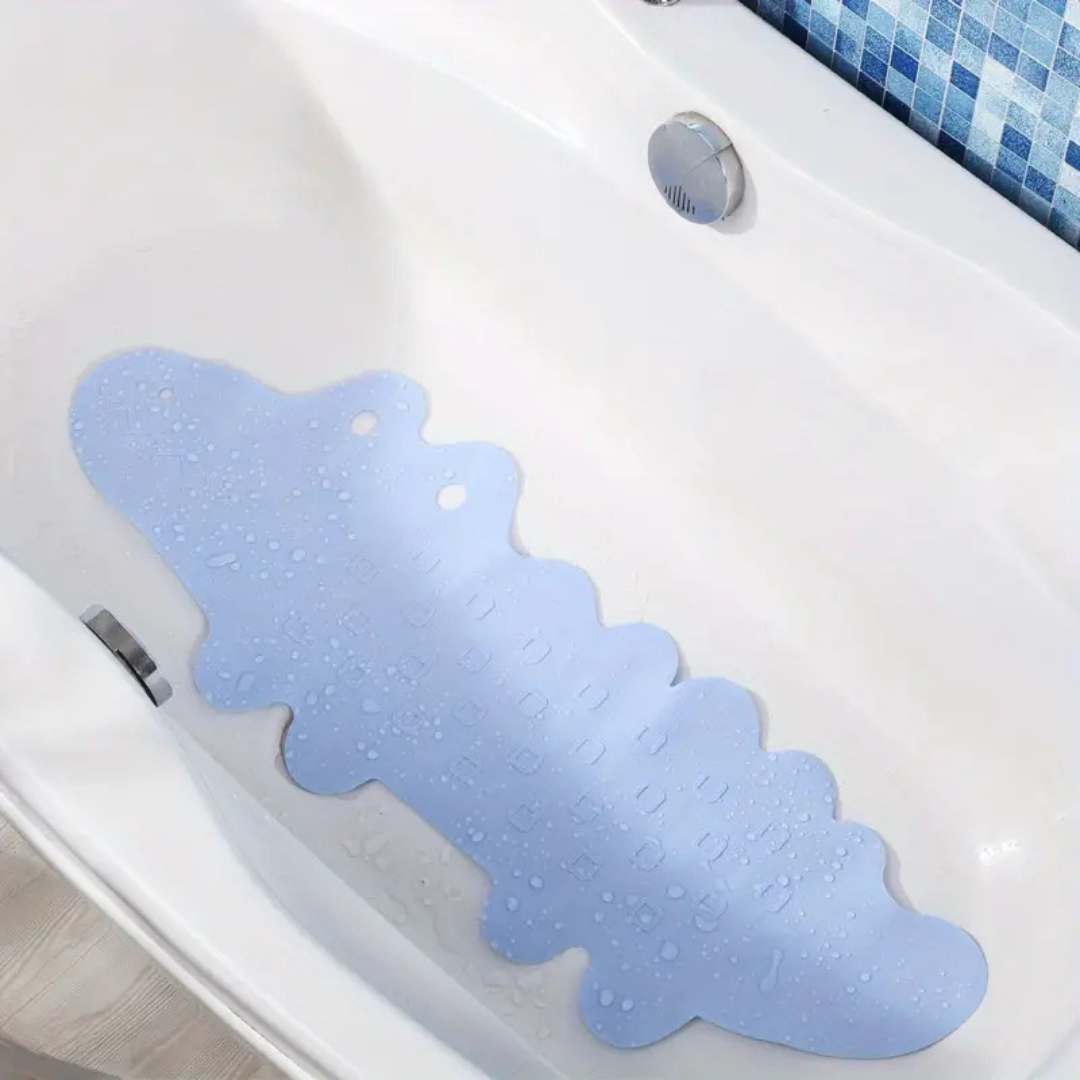 Blue crocodile bath mat positioned along the bottom of a white bathtub