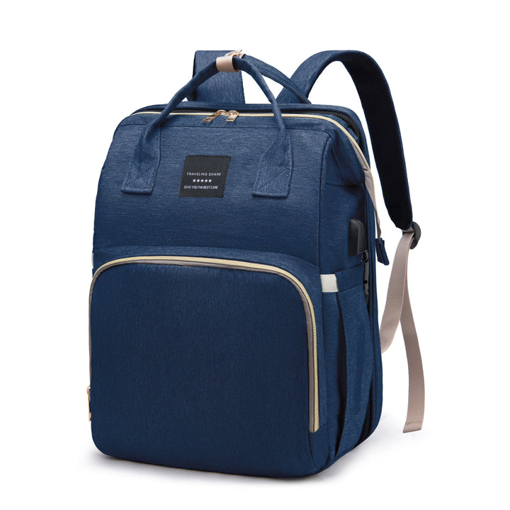 Blue diaper backpack with top handles and zippered main and front compartments.