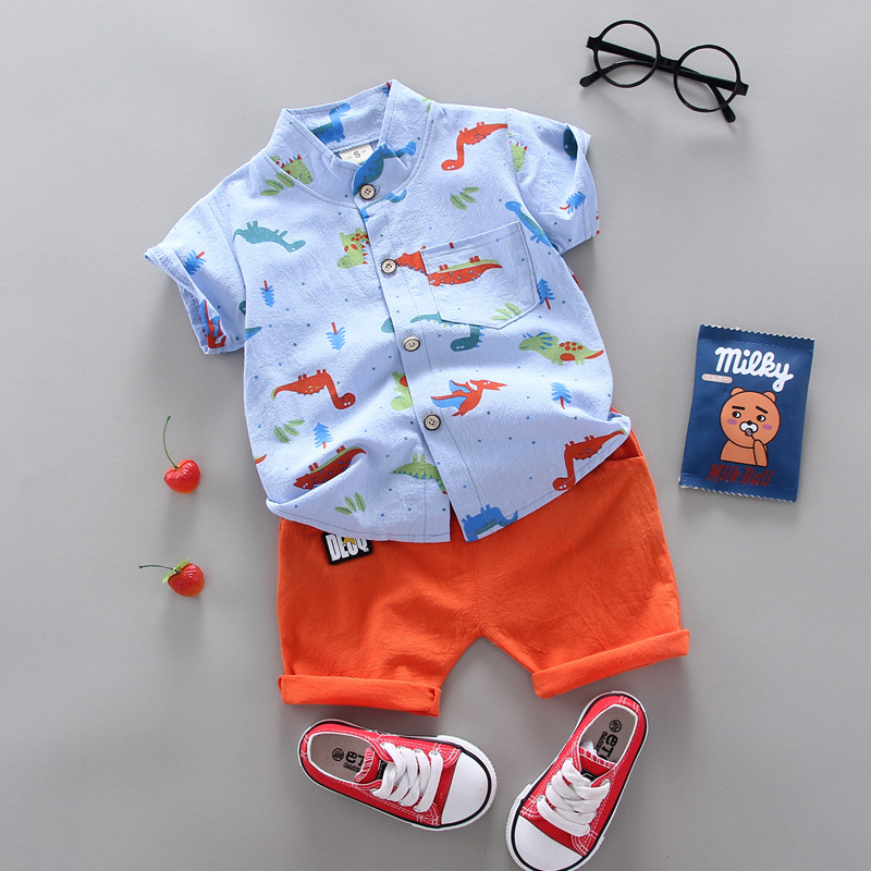 Blue short-sleeve dinosaur shirt paired with orange cuffed shorts