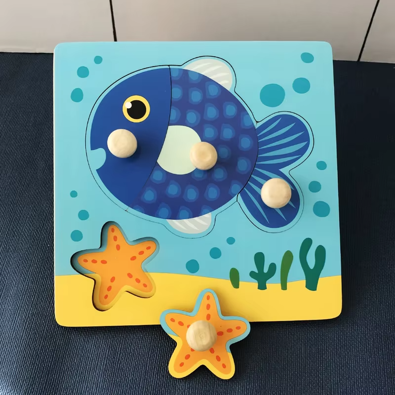 Fish wooden peg puzzle with a large blue fish and a removable starfish piece
