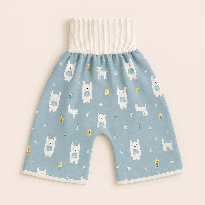 Blue forest-animal training pants laid flat on a peach background