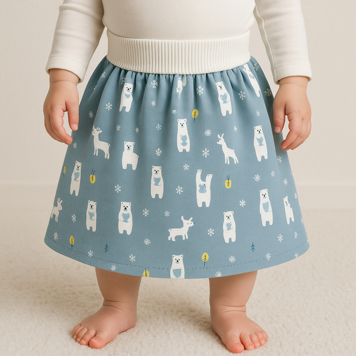 Child wearing a blue forest-animal training skirt with a wide white waistband