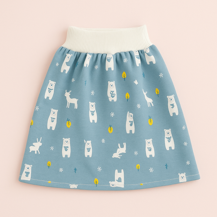 Blue forest-animal training skirt laid flat on a pink background