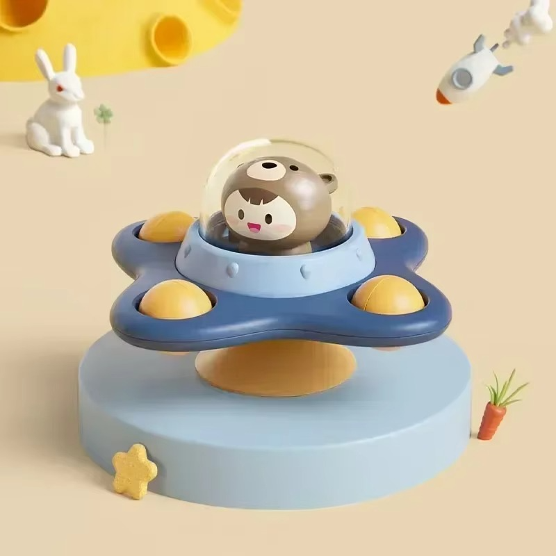 Bear character under a clear dome on a blue four-lobed spinner with yellow accents