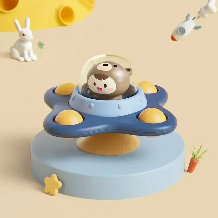 Bear character under a clear dome on a blue four-lobed spinner with yellow accents