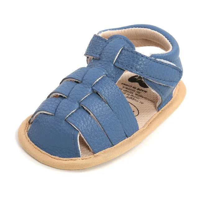 Blue baby sandal with interwoven toe straps and a hook-and-loop ankle closure