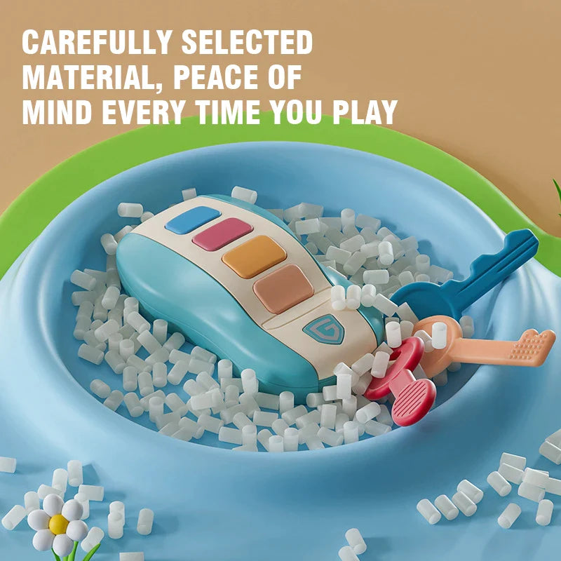 Blue musical key-fob toy and colorful keys displayed in a bowl of white pellets