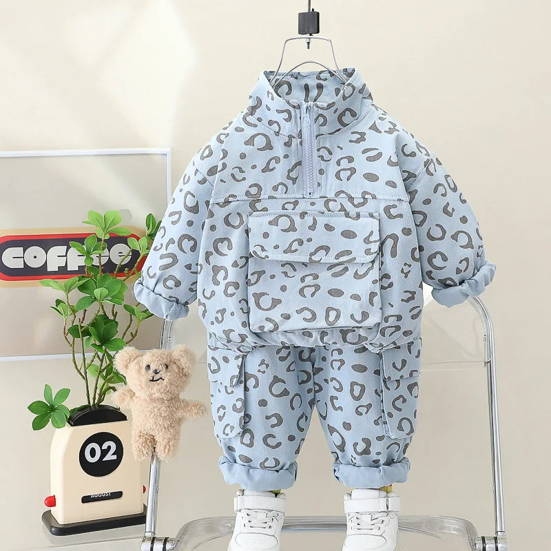 Front view of the blue leopard print half-zip top and matching cuffed pants.