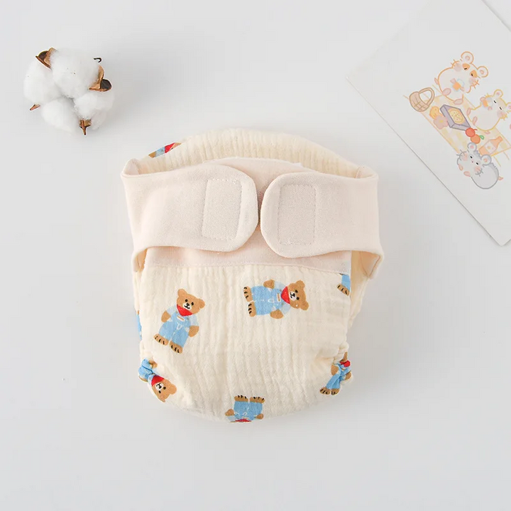 Cloth diaper with bears in blue outfits and a cream waistband