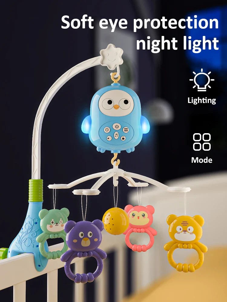 Blue owl crib mobile with illuminated sides and colorful animal hangers mounted on a crib rail.