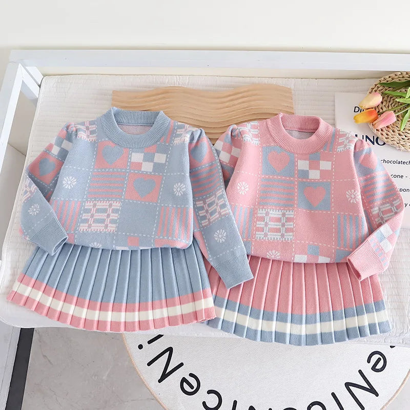 Blue and pink sweater-and-skirt sets shown side by side, with patterned sweaters and pleated skirts