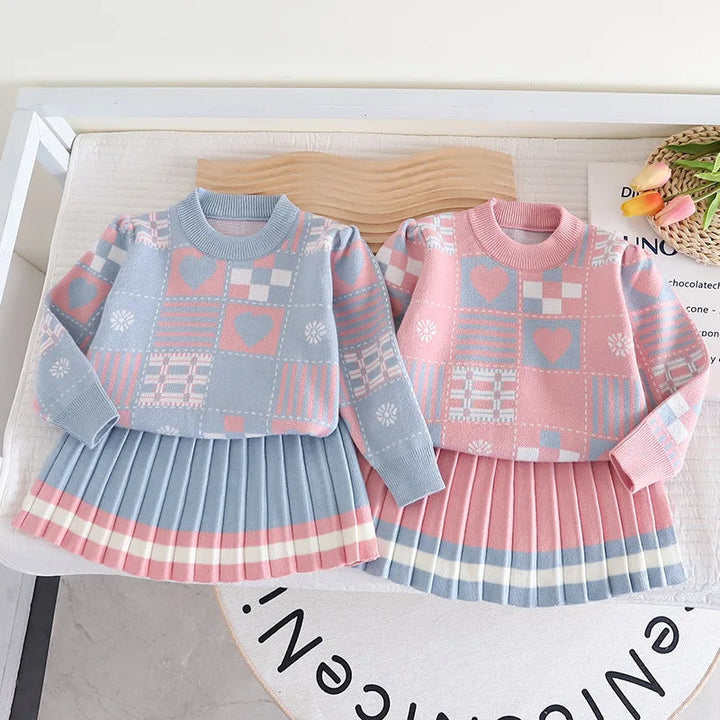 Blue and pink sweater-and-skirt sets shown side by side, with patterned sweaters and pleated skirts