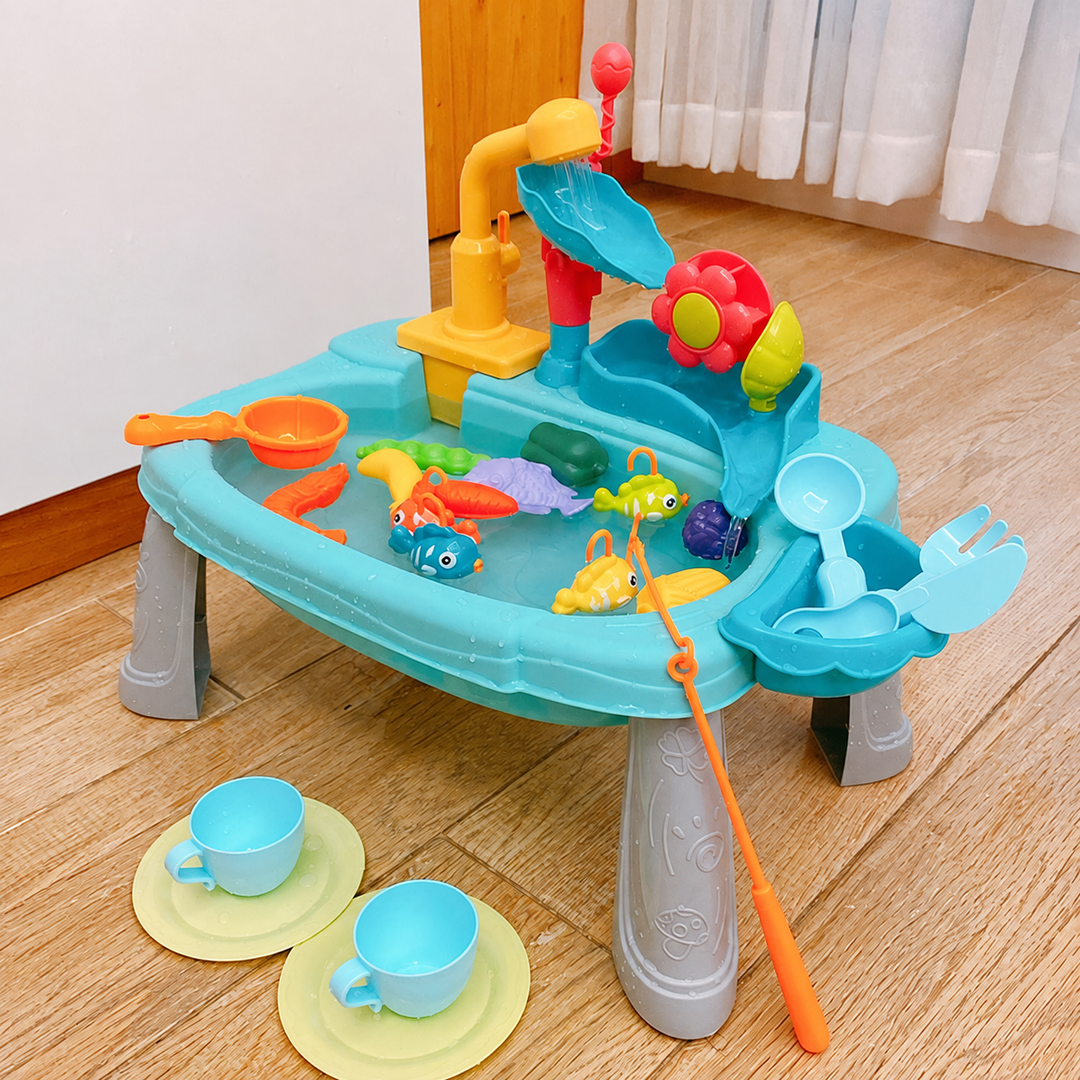 Blue water-play sink with fishing accessories and two cups resting on plates beside the basin