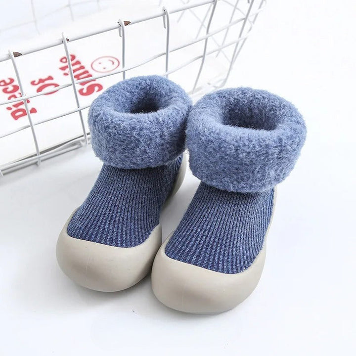 Blue ribbed baby socks with plush folded cuffs and light-colored soles