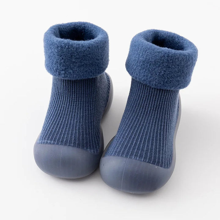 Blue sock shoes with folded cuffs, ribbed uppers, and rounded rubber toes.