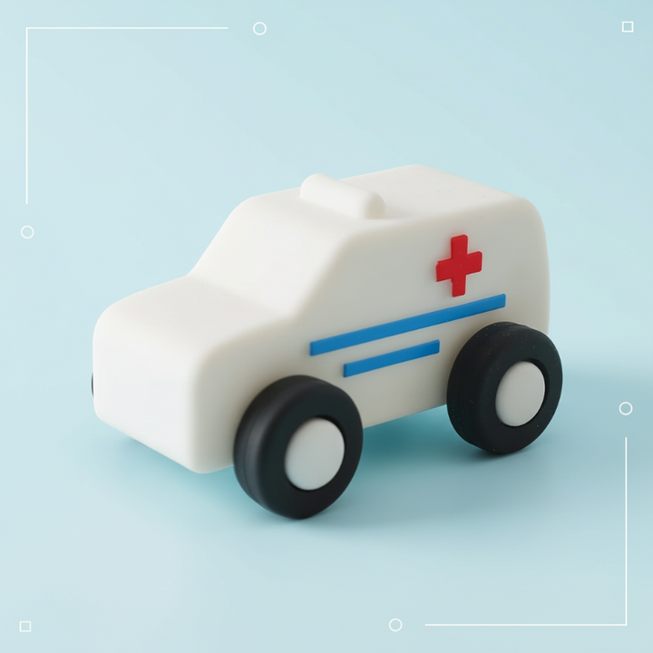 White toy ambulance with blue stripes, a red cross and black wheels
