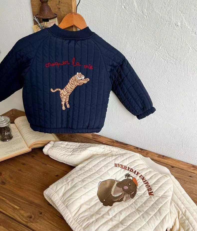 Blue tiger and white animal-embroidered quilted jackets displayed together