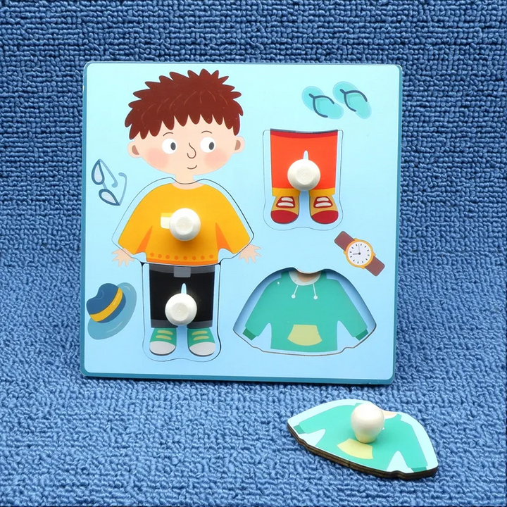 Boy dress-up wooden peg puzzle with a hoodie piece placed beside the board