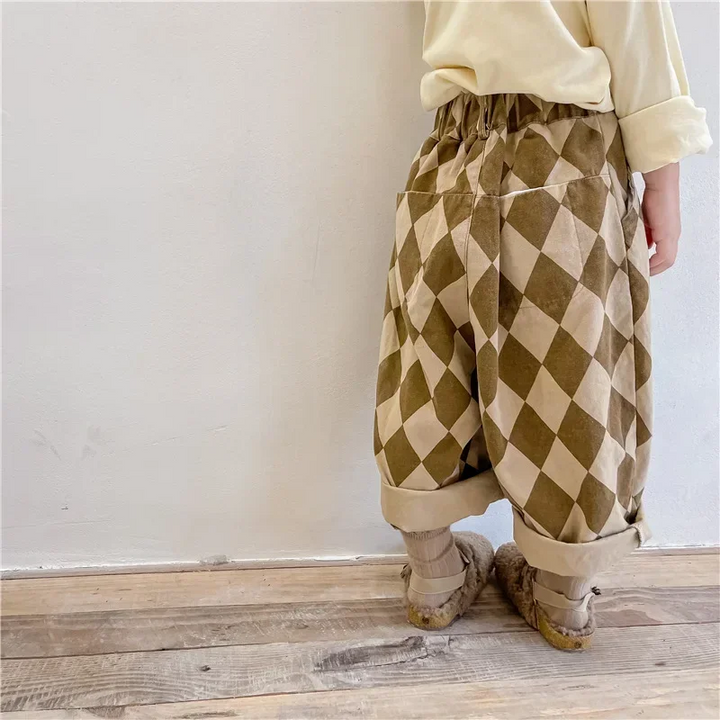 Side view of brown argyle pants showing a front pocket and turned-up cuffs