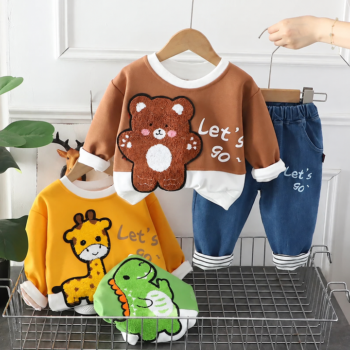 Brown bear sweatshirt and blue pants displayed with yellow giraffe and green dinosaur tops