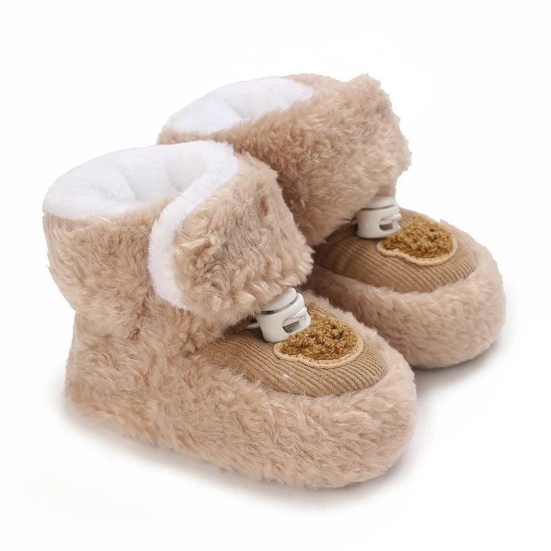 Brown plush baby shoes with bear patches, broad ankle cuffs, and white lining.