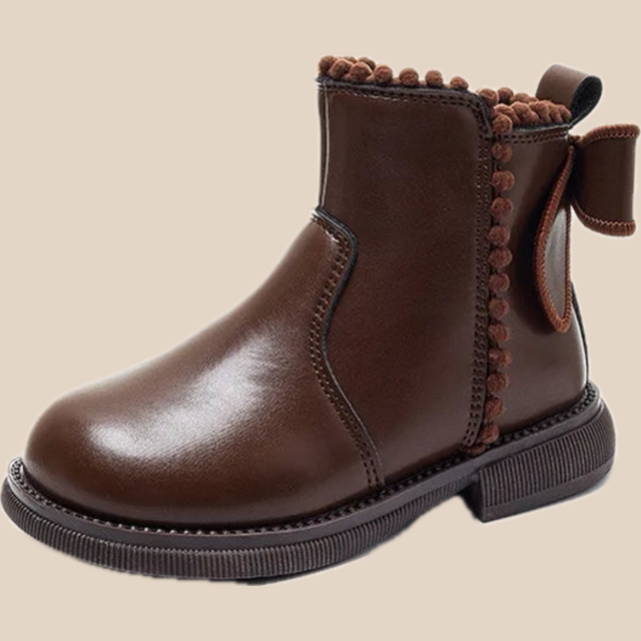 Brown ankle boot with a back bow, decorative trim, and a thick dark sole
