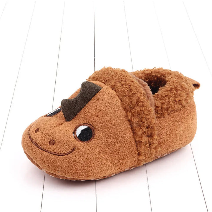 Brown dragon baby slipper with a smiling face and dark crest.
