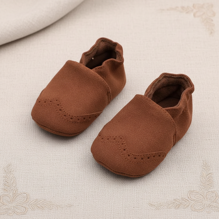 Brown slip-on baby shoes with soft uppers and elastic ankle openings