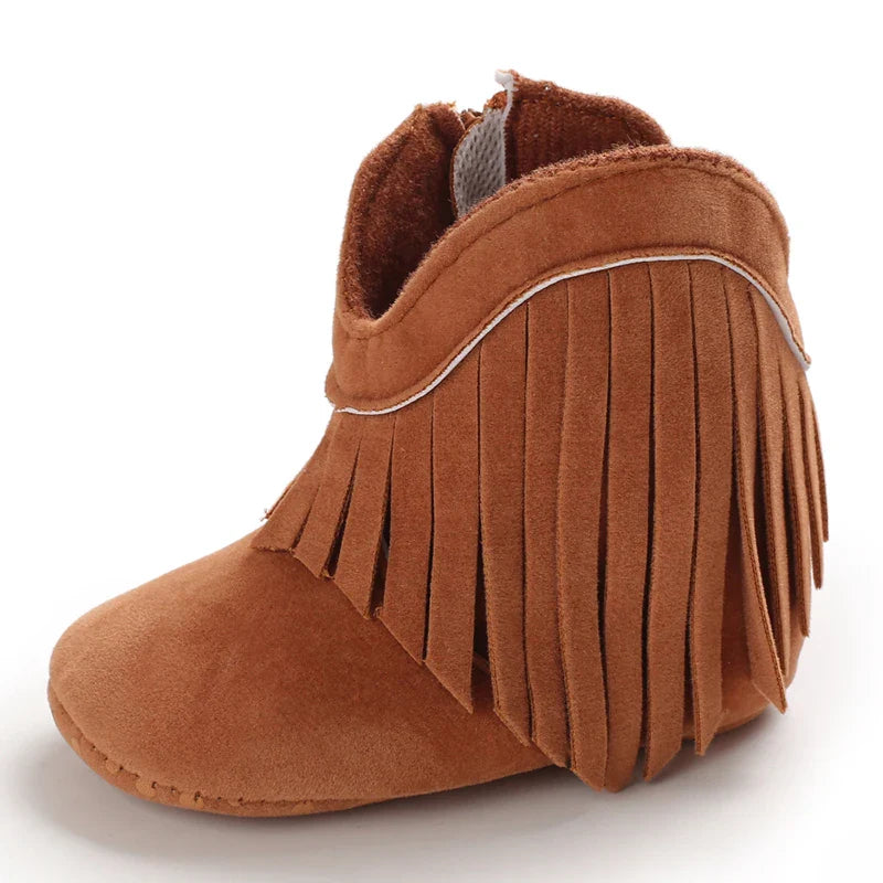 Side view of a brown baby cowboy boot with fringe trim and a rounded toe