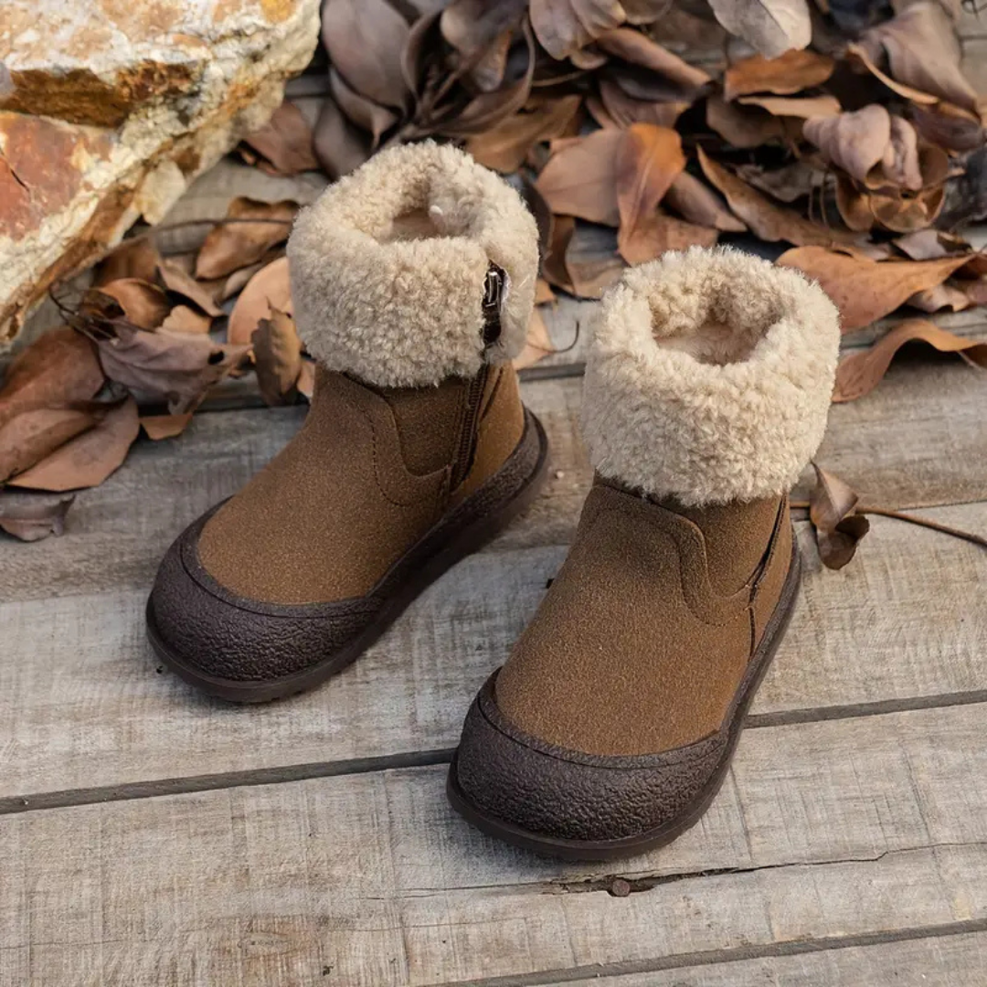 Front view of brown kids' winter boots with cream fleece cuffs and dark textured soles.