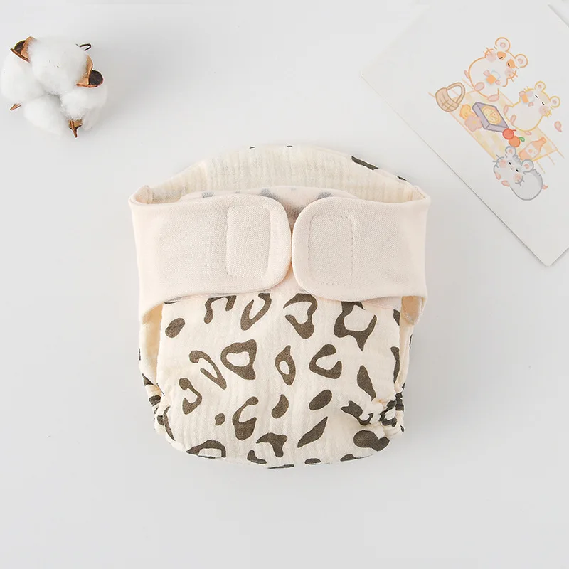 Cloth diaper with brown leopard spots and a cream waistband
