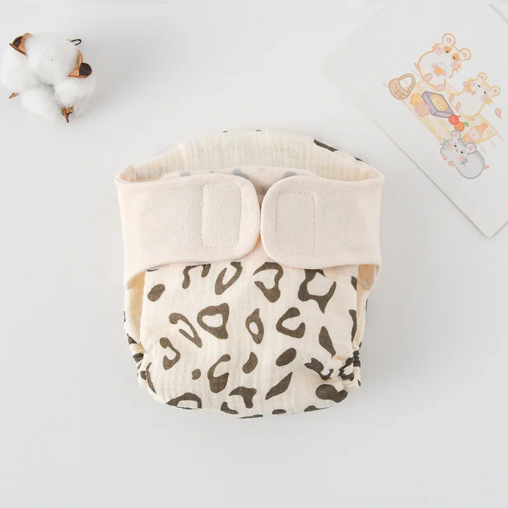 Cloth diaper with brown leopard spots and a cream waistband