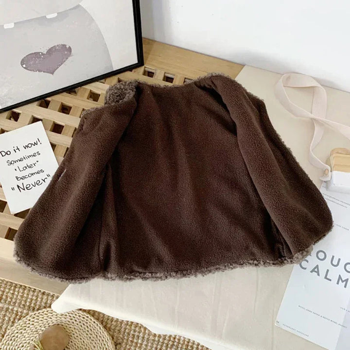 Brown plush vest opened to reveal its finer-textured fabric interior