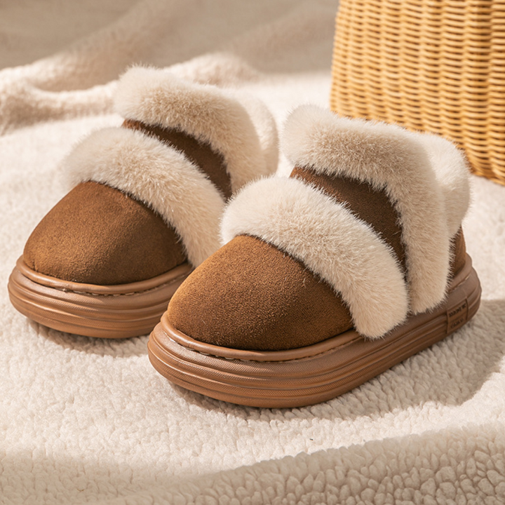 Brown suede ankle boots with cream plush trim on a blanket beside a woven basket.