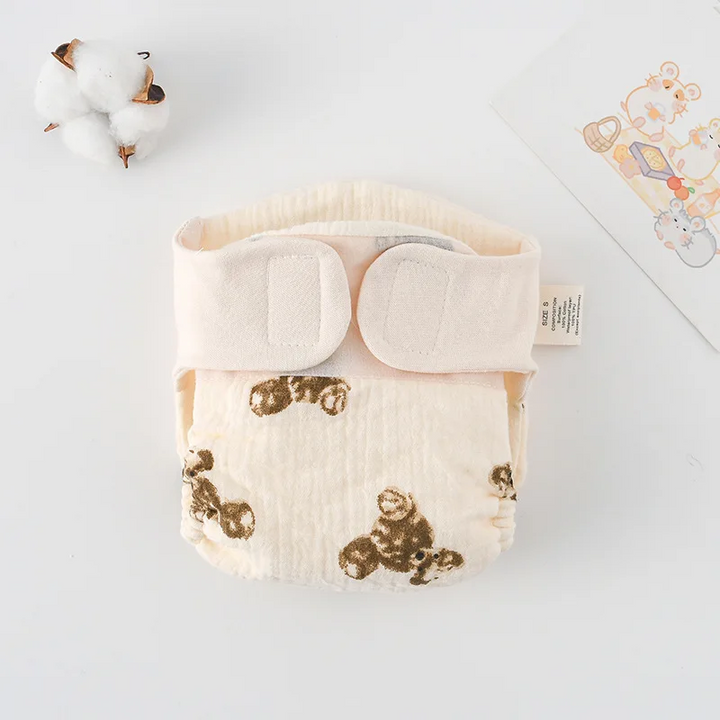 Cloth diaper with brown teddy bear prints and cream fastening tabs