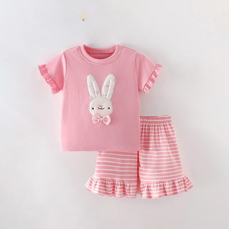 Pink bunny-graphic top displayed with pink striped shorts and ruffled hems