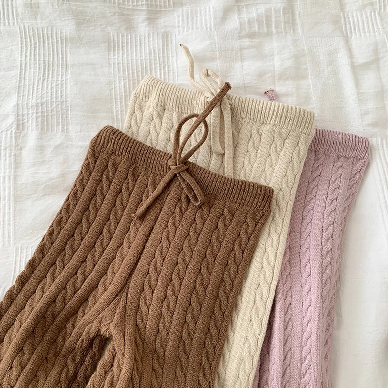 Brown, beige, and pink cable-knit pants showing drawstring waistbands