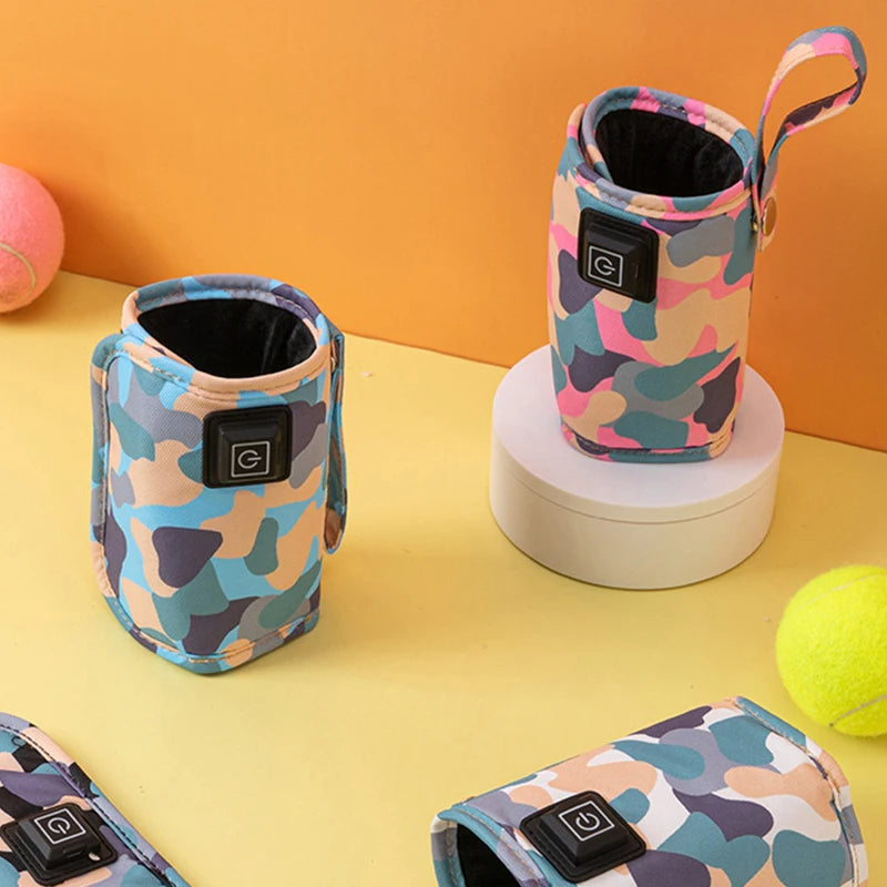 Pink and blue camouflage bottle-warmer sleeves standing open, with other sleeves laid flat.