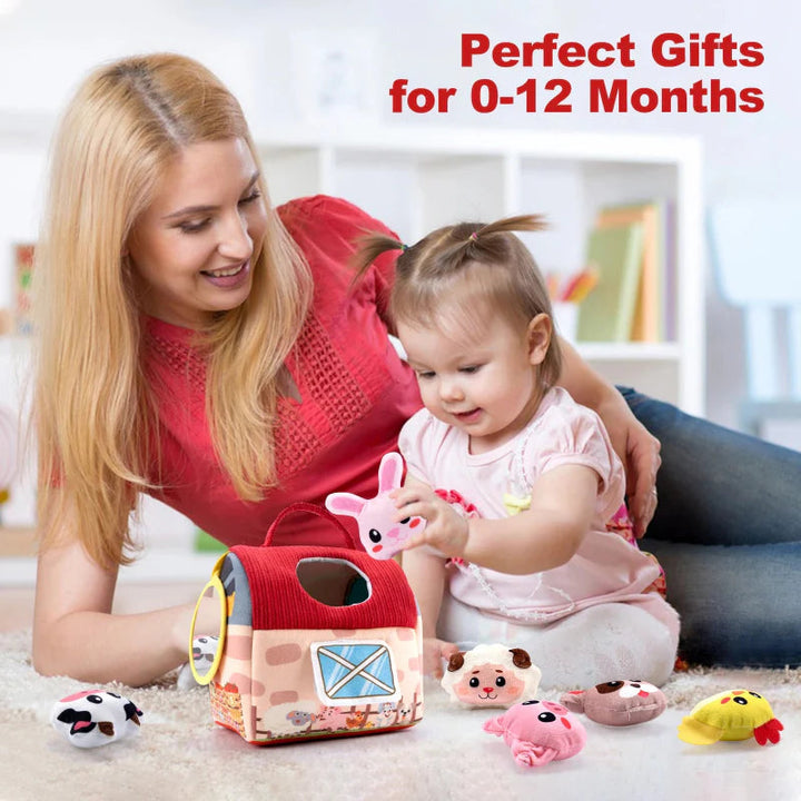 Caregiver and baby playing together with the soft farmhouse and plush animals