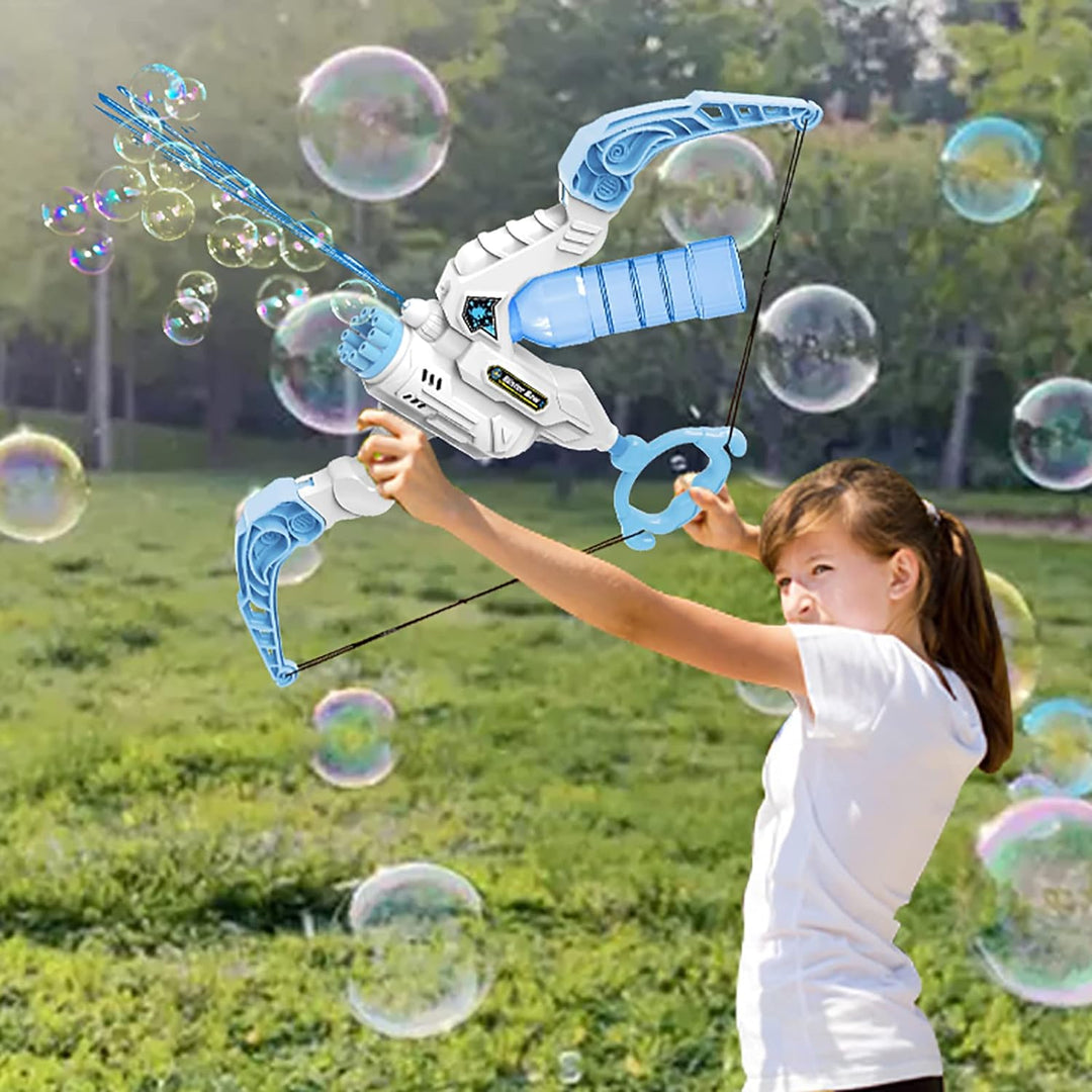 Child holding a blue-and-white bubble bow outdoors with bubbles floating around