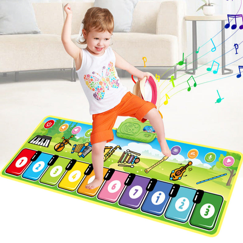 Child lifting one foot over the numbered keys of a musical play mat