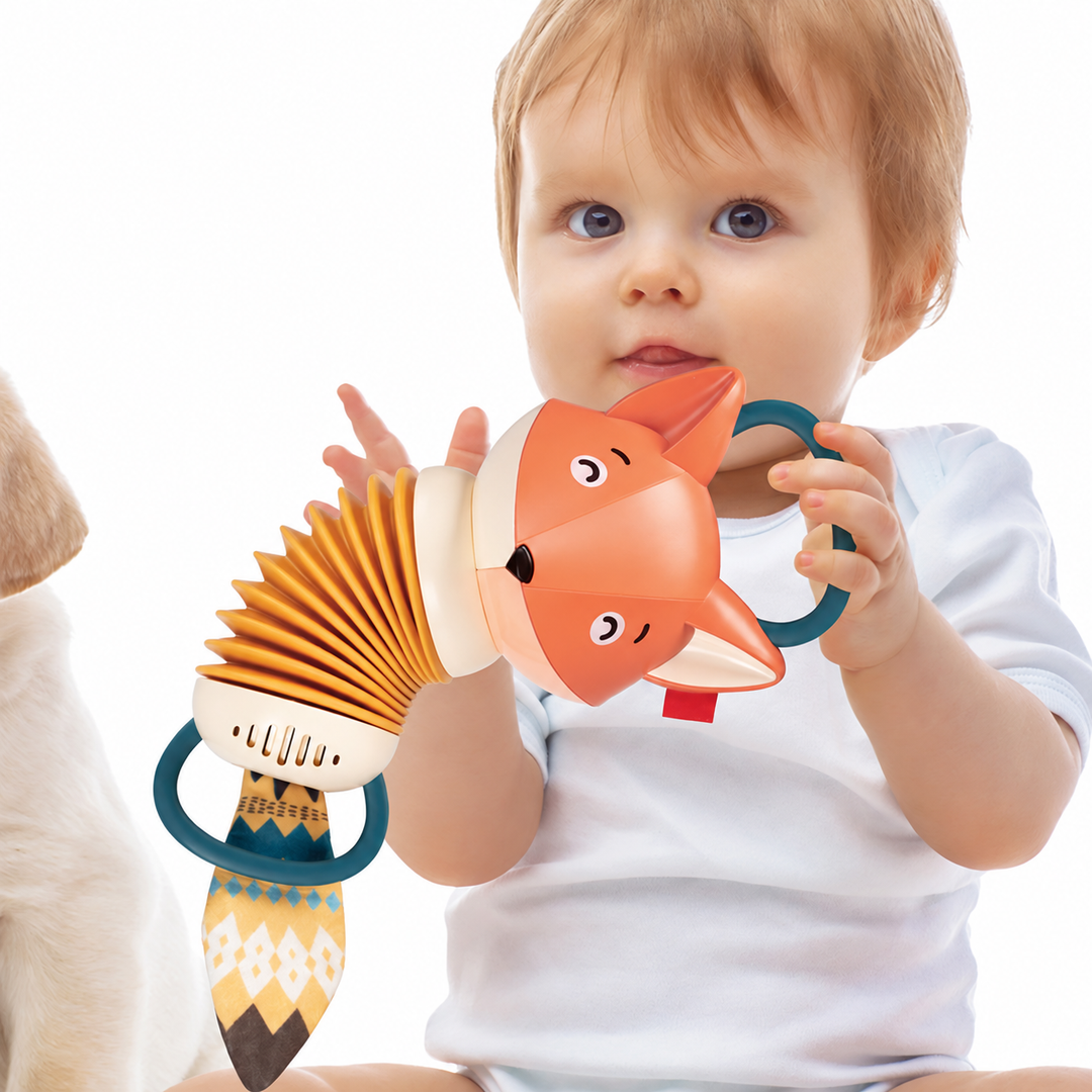 Child holding the fox-shaped musical toy by its teal handles