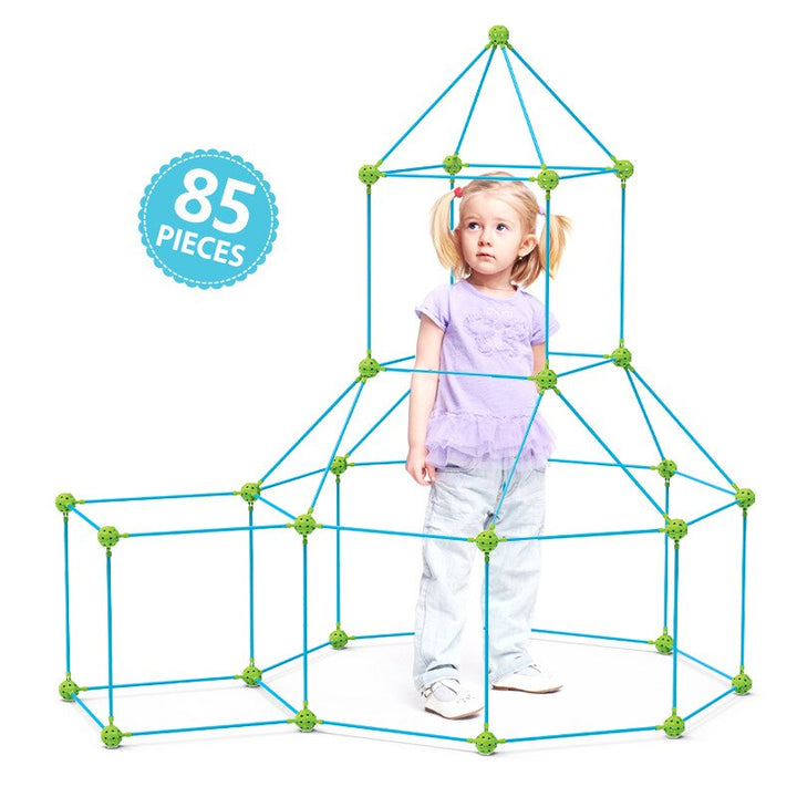 Child standing inside a castle-style frame built with the 85-piece fort kit