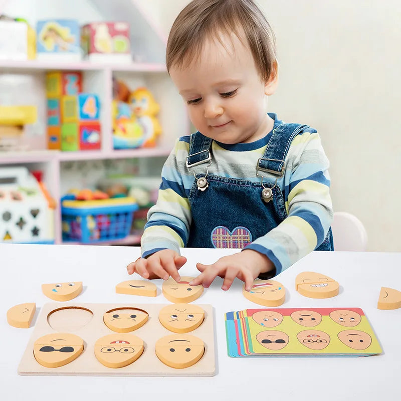Child fitting wooden face pieces into the expression puzzle board beside matching cards