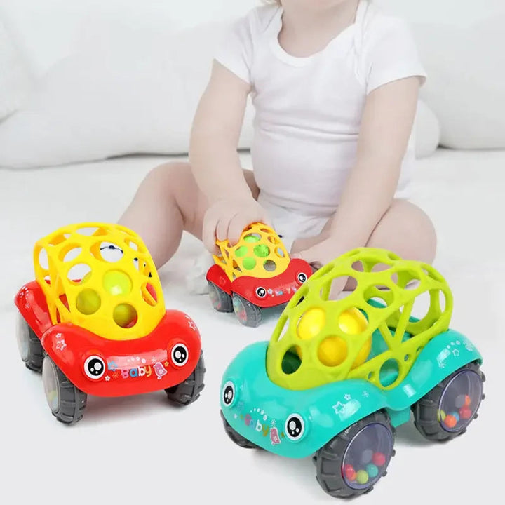 Child seated with red and green rattle toy cars featuring open lattice tops