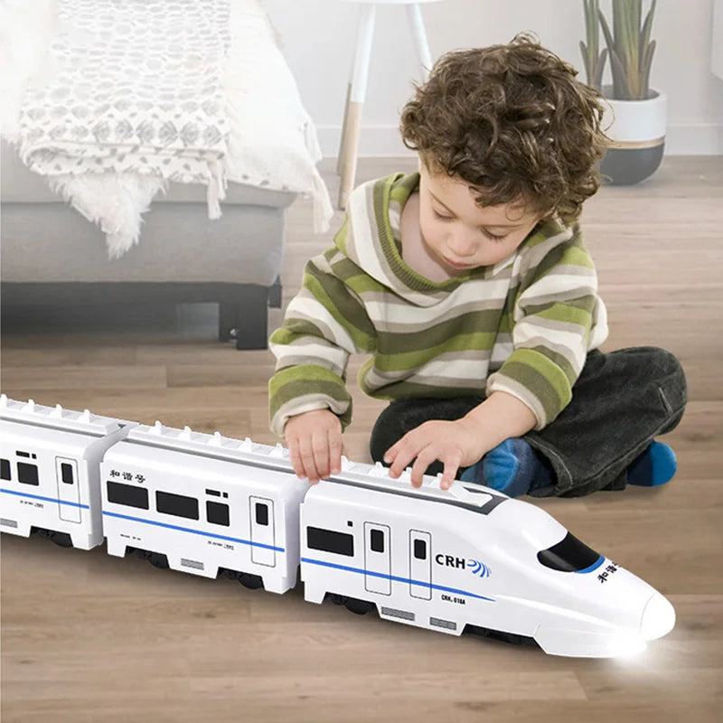 Child playing with a white and blue toy train on the floor